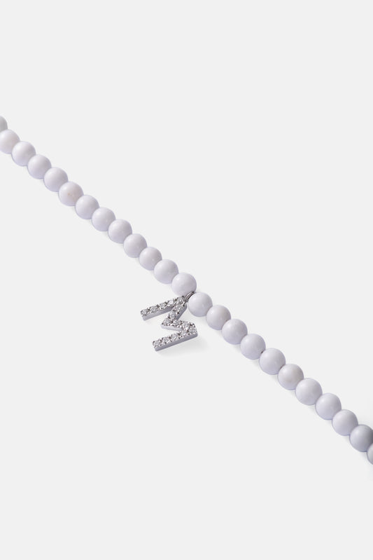 tridacna choker with white gold diamond letter