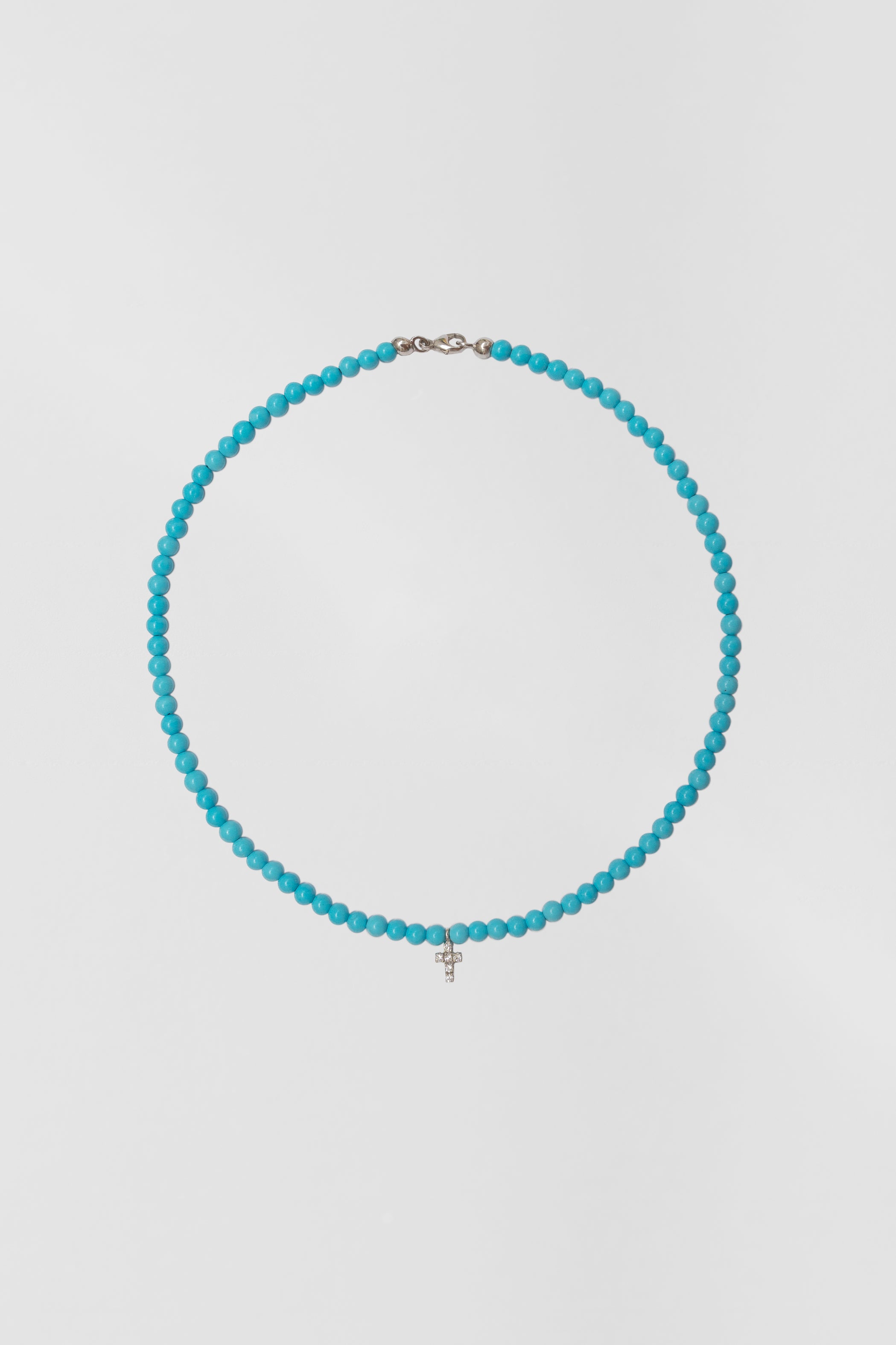 turquoise choker with big white gold diamond cross