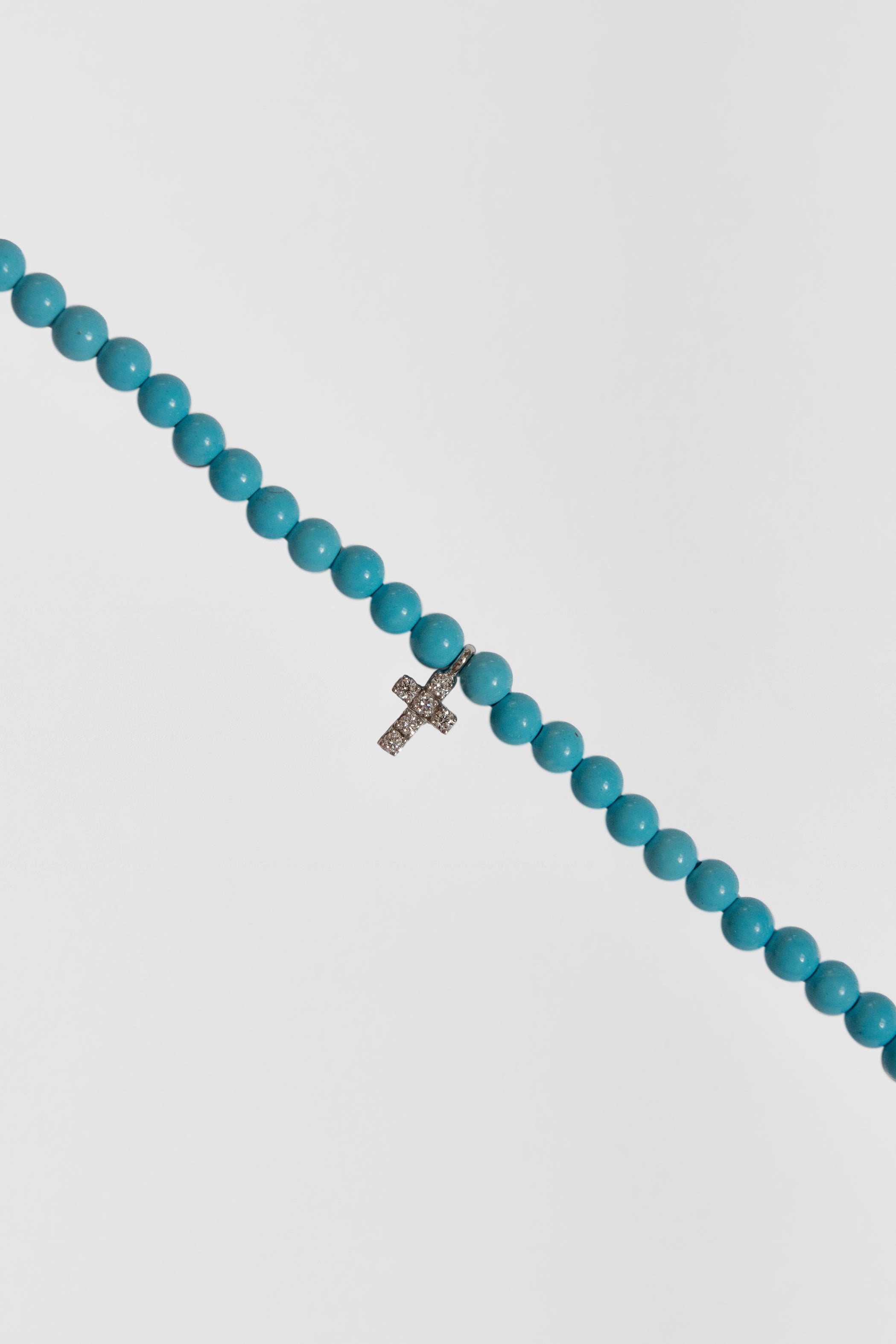 turquoise choker with big white gold diamond cross